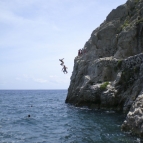 Sam and ET posing ninja-style off the cliffs at Kamari Beach