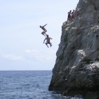 Sam and ET posing ninja-style off the cliffs at Kamari Beach