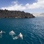 Squino, ET and Pete swimming off of Nea Kameni with Santorini in the background