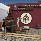 Lisa in front of an old press at Koutsoyannopoulos Winery