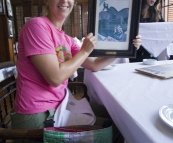 Lisa holding the menu at Cafe Batavia