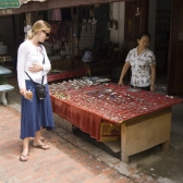 Lisa checking out the merchandise at a stall down Luang Prabang\'s main drag