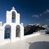 Church bells in Firostefani and the town of Imerovigli in the distance