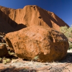 A piece of Uluru and the hole from which it tumbled in the background