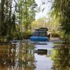 A Land Rover crossing the creek on the road into Tjaynera Falls