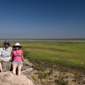 Sam and Lisa on the edge of the sandstone escarpment with wetlands below at the Ubirr Aboriginal art site