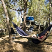 Lisa relaxing with a beer at our campsite at Cooinda