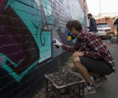 Working on the graffiti wall down the side of Mi-Life shoe store