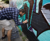 Working on the graffiti wall down the side of Mi-Life shoe store