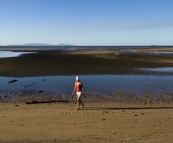 Lisa on the beach in front of our campsite at Toomulla