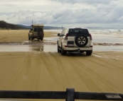 The Tank and Peter crossing one of the many freshwater streams running into the ocean along the eastern beach