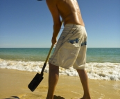 Sam digging for cockles at Sandy Cape