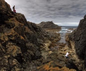 Lisa, Greg and Grant clambering on the rocks on the way into the cave at Seal Rocks