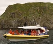 One of the Bruny Island Cruises boats amongst rocks known as The Friars