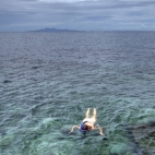 Lisa snorkeling at Cape Jeda Gang with Ko Phangan in the distance