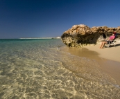 Lisa relaxing on our private beach below the campsite at Osprey Bay