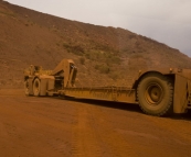 An empty sled next to a regular truck at Tom Price mine