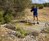 Lisa pumping some water out of the old well at Black Springs