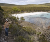 Lisa on the walking trail around Memory Cove with the beach campsite in the background