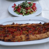 A beef pide and green salad