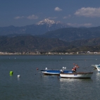 Fishing boats in Fethiye Bay with snow-capped peaks in the distance
