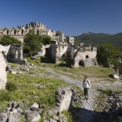 Lisa in the ghost town of Kayakoy with a 17th century church in the background