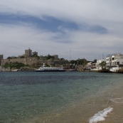 View of the Bodrum castle and beachfront restaurants in the eastern bay