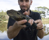 Sam and an Eastern Water Dragon on the banks of the Snowy River