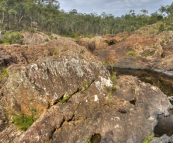 The red rocks at the top of Raymond Falls