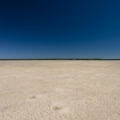 Lisa and the seemingly endless tidal mud flats near Pago