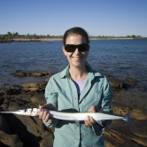 Lisa catches a Snook fishing off the rocks north of Pago