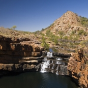 Lisa standing at the top of the waterfall at Bell Gorge