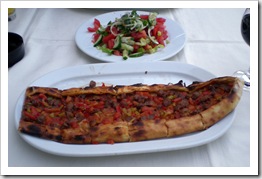 A beef pide and green salad