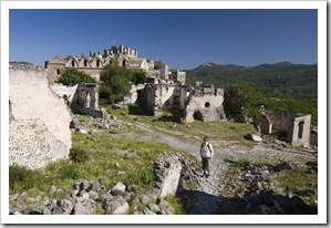 Lisa in the ghost town of Kayakoy with a 17th century church in the background