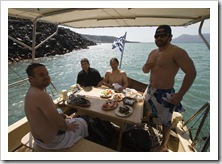 Squino, Greg, Tariq and ET with the volcanic rocks of Nea Kameni in the background