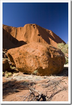 A piece of Uluru and the hole from which it tumbled in the background