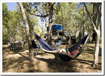 Lisa relaxing with a beer at our campsite at Cooinda