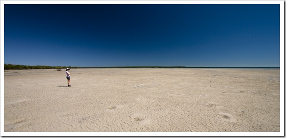 Lisa and the seemingly endless tidal mud flats near Pago