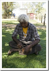An Aboriginal in Fitzroy Crossing carving a Boab nut