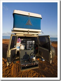 Our stove sits on a removable shelf on the end of one of the roller drawers, the gas for the stove is located inside the cab and can be hooked up with an extension gas line