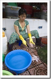 Skinning fresh frogs in Ben Tanh Market