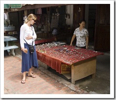 Lisa checking out the merchandise at a stall down Luang Prabang's main drag