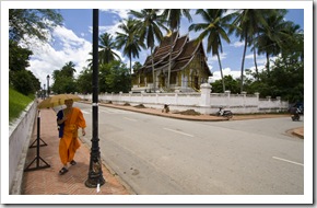 A monk walking in front of the wat at the Royal Palace Museum