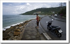 Lisa taking a rest next to our moped on our ride along the northwest coast of Phuket