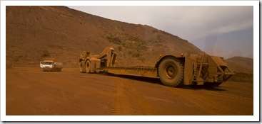 An empty sled next to a regular truck at Tom Price mine