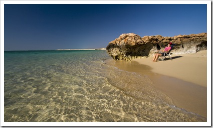 Lisa relaxing on our private beach below the campsite at Osprey Bay