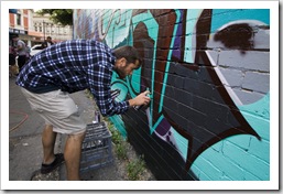 Working on the graffiti wall down the side of Mi-Life shoe store