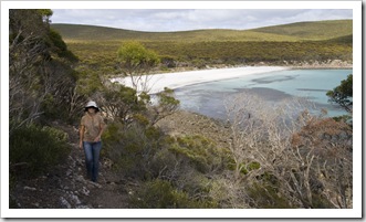 Lisa on the walking trail around Memory Cove with the beach campsite in the background