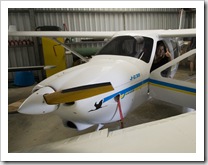 Lisa in the cockpit of Grant's ultralight Jabiru plane