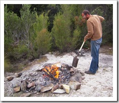 Sam tending to the fire by the Lindsay River